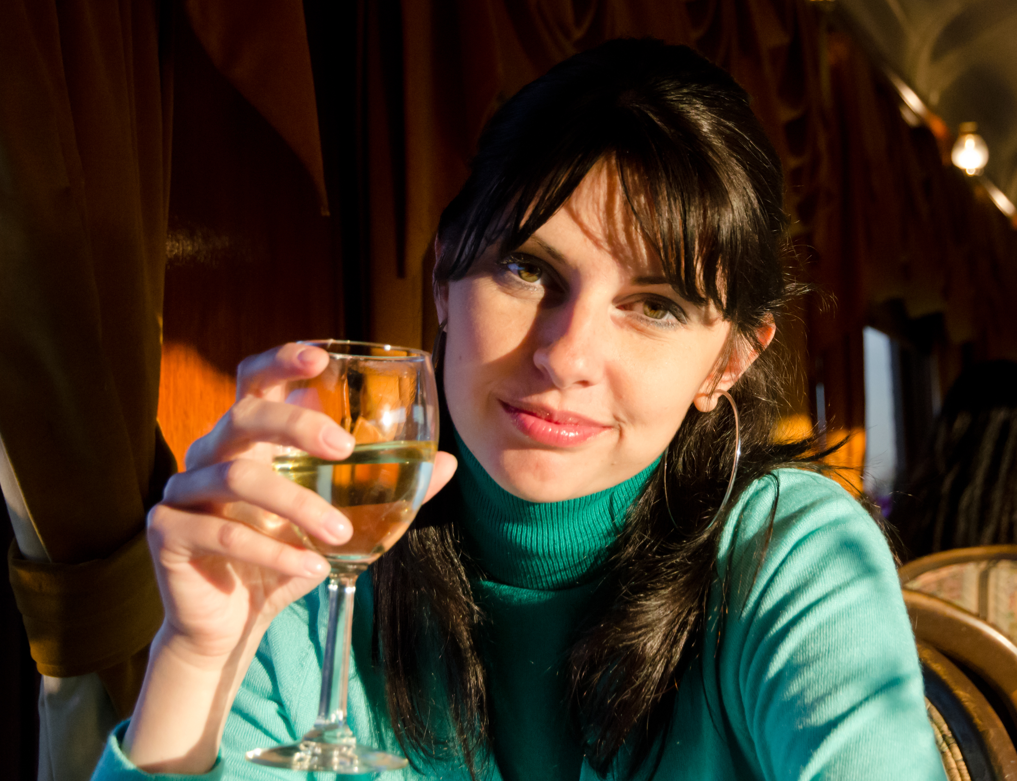 Young female enjoys wine.